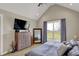 Vaulted ceiling Primary bedroom with plush carpet and large window overlooking yard at 706 E 750 N, Lebanon, IN 46052