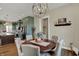 Dining room features wood floors, neutral color palette, chandelier with open access to kitchen at 706 E 750 N, Lebanon, IN 46052