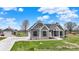Grey farmhouse with black framed windows, black roof, and a concrete driveway at 706 E 750 N, Lebanon, IN 46052