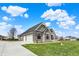View of the house featuring a three-car garage, complemented by lush green grass and blue sky at 706 E 750 N, Lebanon, IN 46052
