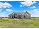 Grey modern farmhouse-style home with a dark roof and a well-manicured lawn at 706 E 750 N, Lebanon, IN 46052