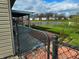 The backyard with the view of a pond, a fence and neighboring houses at 7201 Barnwell Pl, Indianapolis, IN 46217