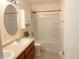 Bathroom showcasing a vanity, toilet, and shower-tub combination at 7201 Barnwell Pl, Indianapolis, IN 46217