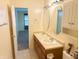 Bathroom featuring a double vanity and doorway to another room at 7201 Barnwell Pl, Indianapolis, IN 46217