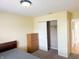 Cozy bedroom featuring neutral walls, carpeted floor, closet, and a wooden dresser for storage at 7201 Barnwell Pl, Indianapolis, IN 46217