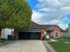 Charming brick home with an attached garage, well-manicured lawn, and beautiful landscaping at 7201 Barnwell Pl, Indianapolis, IN 46217