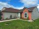 Well-maintained home featuring manicured lawn, mature trees, and carefully arranged flowerbeds at 7201 Barnwell Pl, Indianapolis, IN 46217