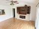 Bright living room with laminate flooring, a decorative fireplace, and a mounted television at 7201 Barnwell Pl, Indianapolis, IN 46217