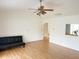 Inviting living room with wood flooring, neutral walls, and a comfortable futon for relaxing at 7201 Barnwell Pl, Indianapolis, IN 46217