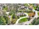 Aerial view of an estate home surrounded by lush greenery, mature trees, and a circular driveway at 7545 Chablis Cir, Indianapolis, IN 46278