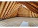 Unfinished attic shows wooden beams, unfinished floor, and sunlight at 7545 Chablis Cir, Indianapolis, IN 46278