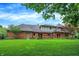 Expansive backyard featuring a large deck and brick exterior of the home at 7545 Chablis Cir, Indianapolis, IN 46278