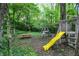 Backyard featuring a playset and a picnic table nestled in the trees at 7545 Chablis Cir, Indianapolis, IN 46278