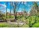Sprawling backyard featuring a playset, picnic table, and fire pit, ideal for outdoor gatherings and relaxation at 7545 Chablis Cir, Indianapolis, IN 46278