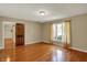 Bright bedroom boasts hardwood floors, natural light, and a neutral color scheme at 7545 Chablis Cir, Indianapolis, IN 46278