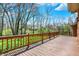 Large wooden deck with railings, offering a serene outdoor space overlooking the lush backyard at 7545 Chablis Cir, Indianapolis, IN 46278