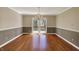 Formal dining room with hardwood floors, wainscotting and chandelier at 7545 Chablis Cir, Indianapolis, IN 46278