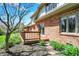 Charming brick home featuring a spacious wooden deck, perfect for outdoor entertaining and enjoying the greenery at 7545 Chablis Cir, Indianapolis, IN 46278
