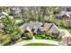 Aerial view of a brick home with a circular driveway and beautiful landscaping at 7545 Chablis Cir, Indianapolis, IN 46278