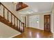 Inviting foyer with hardwood floors, a staircase, and classic trim provides a welcoming entrance to the home at 7545 Chablis Cir, Indianapolis, IN 46278