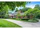 Attractive brick home with a red front door, chimney, and well-maintained lawn with landscaping at 7545 Chablis Cir, Indianapolis, IN 46278