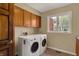 Convenient laundry room with window and storage cabinets at 7545 Chablis Cir, Indianapolis, IN 46278