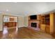 Spacious living room features a brick fireplace and hardwood floors, adjacent to the kitchen at 7545 Chablis Cir, Indianapolis, IN 46278