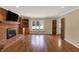 Bright living room features a brick fireplace, hardwood floors, and a large window with a view of the outdoors at 7545 Chablis Cir, Indianapolis, IN 46278