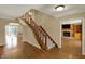 View of the stairs from the foyer, with the living room in the background at 7545 Chablis Cir, Indianapolis, IN 46278