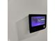 Close-up of a smart thermostat displaying the room temperature and settings for efficient climate control at 7545 Chablis Cir, Indianapolis, IN 46278