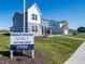 Two-story home with a sign indicating hours, showcasing new construction and community information at 7636 Big Bend Blvd, Camby, IN 46113
