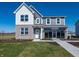 Two-story home with gray siding, brick accents, manicured lawn, and a welcoming entrance at 7636 Big Bend Blvd, Camby, IN 46113