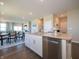 Kitchen island with stainless steel dishwasher, granite countertops and open layout to living area at 7636 Big Bend Blvd, Camby, IN 46113