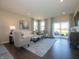 Bright living room with contemporary furnishings, large windows, and a sliding glass door at 7636 Big Bend Blvd, Camby, IN 46113