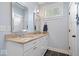 Bathroom boasts double sinks with granite countertops, framed mirrors, white cabinets, and modern fixtures at 7638 Beekman Ter, Zionsville, IN 46077