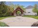 Entryway to a common area with lush landscaping and decorative pavers at 7638 Beekman Ter, Zionsville, IN 46077