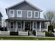 Charming two-story home with a covered front porch and white picket fence at 7638 Beekman Ter, Zionsville, IN 46077