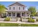 Charming two-story home with a inviting front porch, white picket fence, and lush lawn at 7638 Beekman Ter, Zionsville, IN 46077