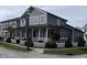 Stylish home showcasing a quaint front porch, white picket fence, manicured landscaping, and Stonegate banner at 7638 Beekman Ter, Zionsville, IN 46077