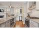 Spacious kitchen featuring stainless steel appliances, gas cooktop, granite countertops, and a kitchen island at 7638 Beekman Ter, Zionsville, IN 46077