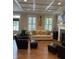 Cozy living room featuring a fireplace, guitar decor, comfortable seating, and coffered ceiling at 7638 Beekman Ter, Zionsville, IN 46077