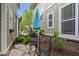 Charming side yard with stone pavers, a bistro set, mature landscaping, and a blue umbrella at 7638 Beekman Ter, Zionsville, IN 46077