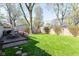 Landscaped backyard featuring a well-maintained lawn and a wooden deck perfect for outdoor living and entertaining at 7735 E 50Th St, Indianapolis, IN 46226
