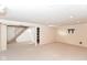 Finished basement with carpeting and stairs, ready for customization and living space expansion at 7735 E 50Th St, Indianapolis, IN 46226