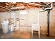 Unfinished basement with utility sink, water softener and exposed plumbing, ready for your personal touch at 7735 E 50Th St, Indianapolis, IN 46226