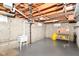 Unfinished basement with exposed ceiling, utility sink and workbench; ideal for storage and DIY projects at 7735 E 50Th St, Indianapolis, IN 46226