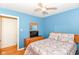 Cozy bedroom with hardwood floors, ceiling fan, and wood dresser with a TV at 7735 E 50Th St, Indianapolis, IN 46226
