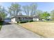 Inviting home exterior, driveway, and manicured front lawn at 7735 E 50Th St, Indianapolis, IN 46226