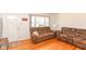 Cozy living room featuring gleaming hardwood floors, a comfortable sofa, and natural light at 7735 E 50Th St, Indianapolis, IN 46226