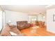 Open-concept living and dining area featuring hardwood floors and abundant natural light at 7735 E 50Th St, Indianapolis, IN 46226